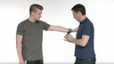 Ein Flossband wird einem Sportler am Unterarm appliziert