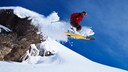 Ein Skifahrer springt über einen Felsvorsprung