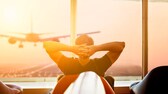 man relaxing at the airport waiting for his plane