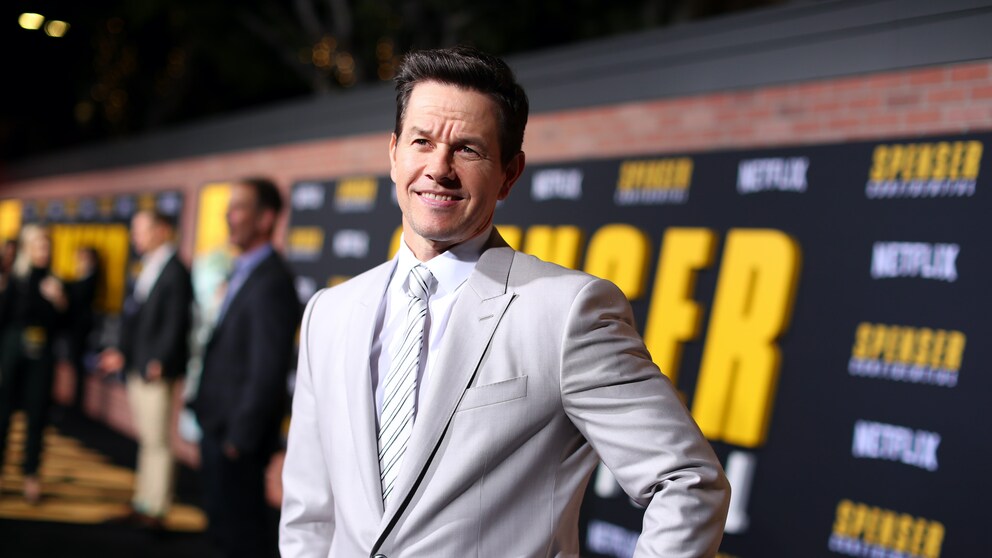 Mark Wahlberg in einem grauen Anzug mit weißem Hemd und Krawatte