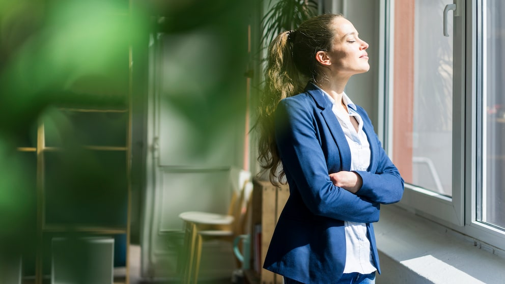 Vitamin D Selbsttest: Frau im Büro scheint Sonne ins Gesicht