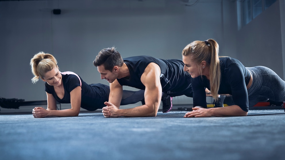 core-stability training: Drei Personen beim Planking