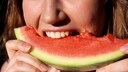 Wassermelone weißer Rand essen: Frau beißt in Wassermelone