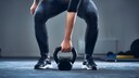 sport leben verlängern: Frau. macht Kettleball-Training