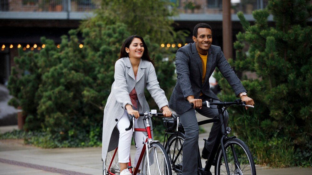 Eine Frau und ein Mann fahren jeweils auf einem Citybike.
