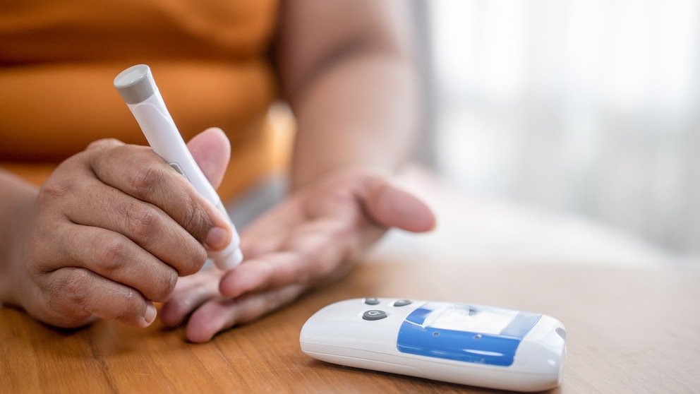 Junger Diabetiker misst seinen Blutzucker