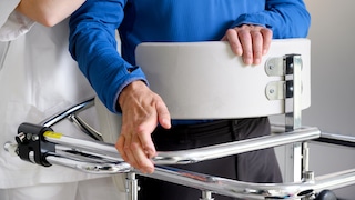 Physiotherapist assisting a patient with Amyotrophic Lateral Sclerosis. High quality photo