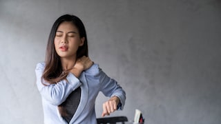 Office syndrome concept.Tired exhausted Asian young  businesswoman work hard shoulder pain after working on computer laptop for a long time.