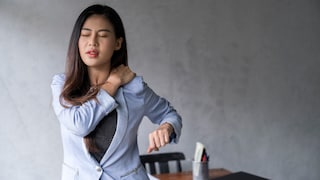 Office syndrome concept.Tired exhausted Asian young  businesswoman work hard shoulder pain after working on computer laptop for a long time.
