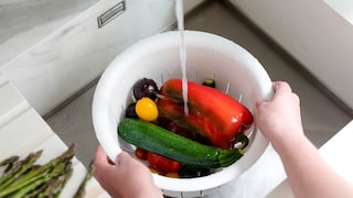 Person wäscht Gemüse