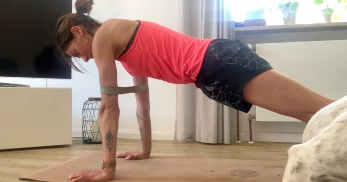 FITBOOK author Nina initially practiced push-ups with a band until she was advanced enough to perform push-ups without aids