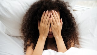 Frau im Bett mit Angst vor Montag