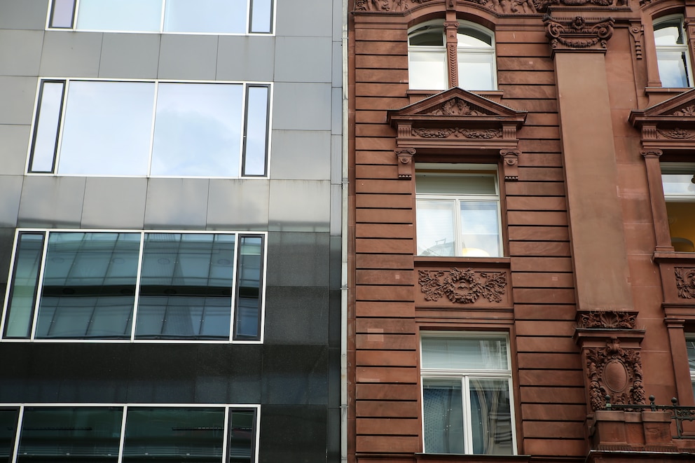 Contrast between facades of an old, pre war residential building, and a new apartment complex in Berlin (Germany), district of Mitte.