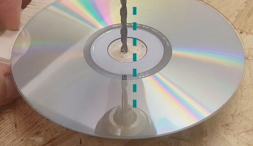 The reflection on the mirrored side of the CD helps with drilling