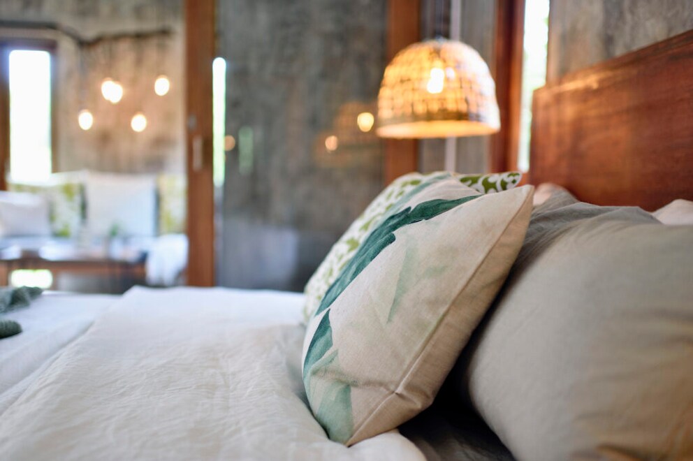 Looks cozy but is unnecessary: too many pillows in the bedroom