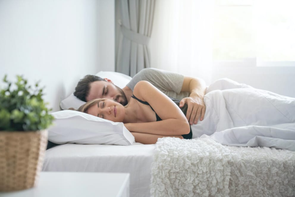 A couple lying in a French bed