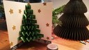 Pop-up-Karte mit Weihnachtsbaum auf einem Holztisch stehend