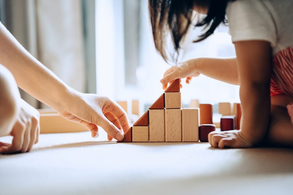 Child building a figure with simple building blocks