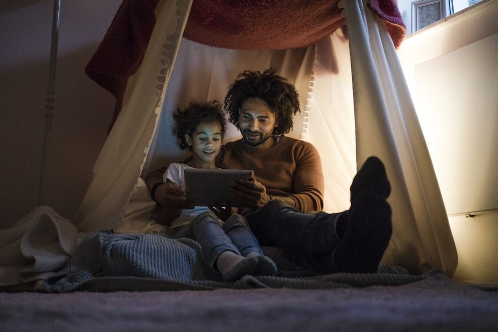 Father reading a story to his daughter in the relaxation area