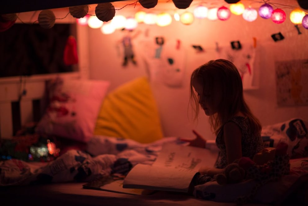 String lights and cushions create a cozy atmosphere in the children's room
