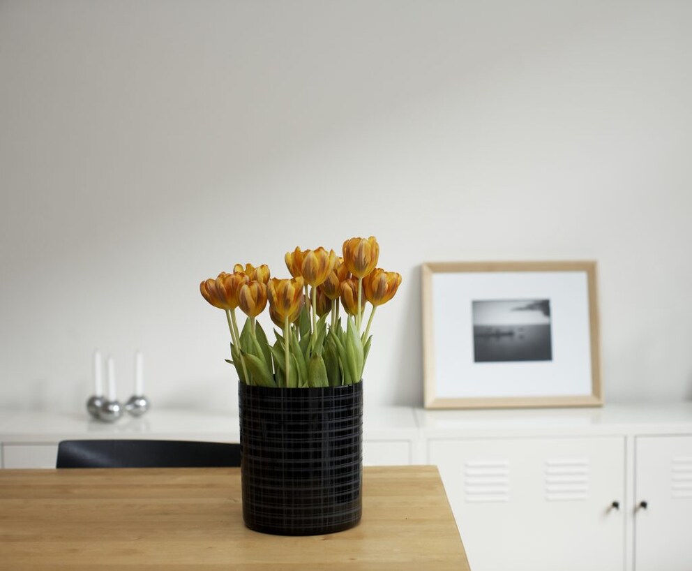 Original vase with fresh flowers on the table