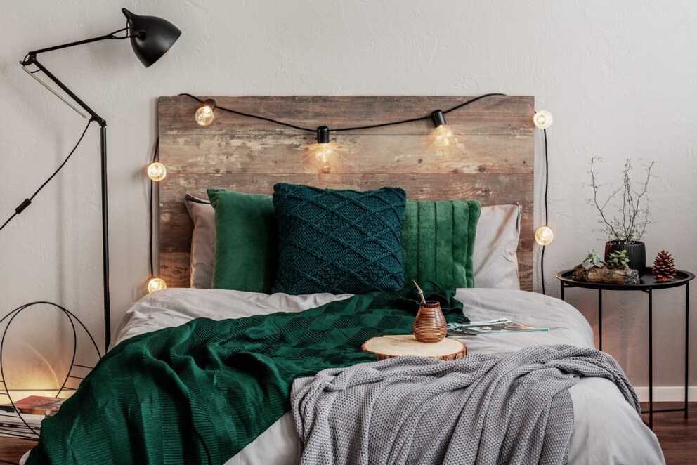 Bedroom with black floor lamp, simple string lights, and a floor light
