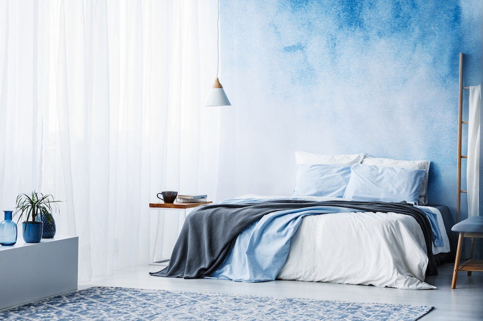 Schlafzimmer mit aquarellierter Wand in Blau