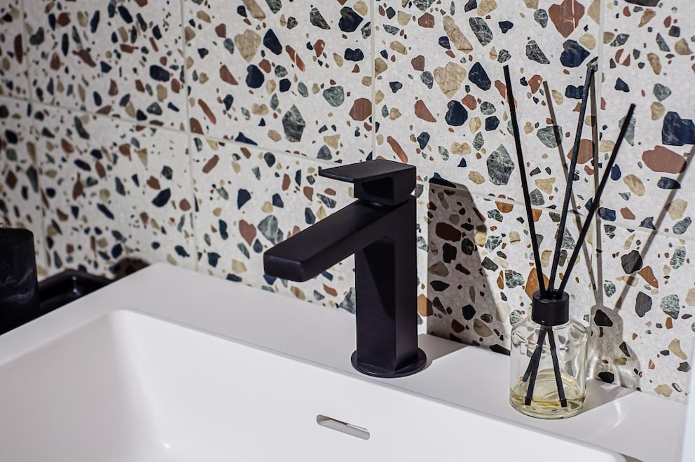 Terrazzo as a wall surface behind the sink in the bathroom