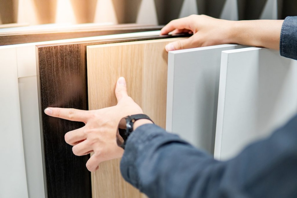 A person choosing between different wood qualities