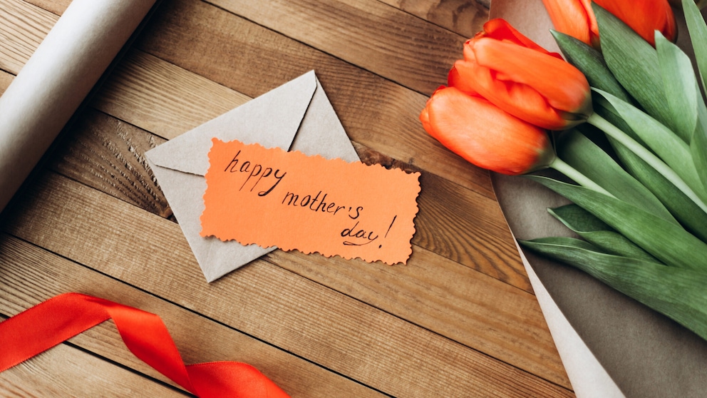 Muttertagskarte mit Blumen auf dem Tisch