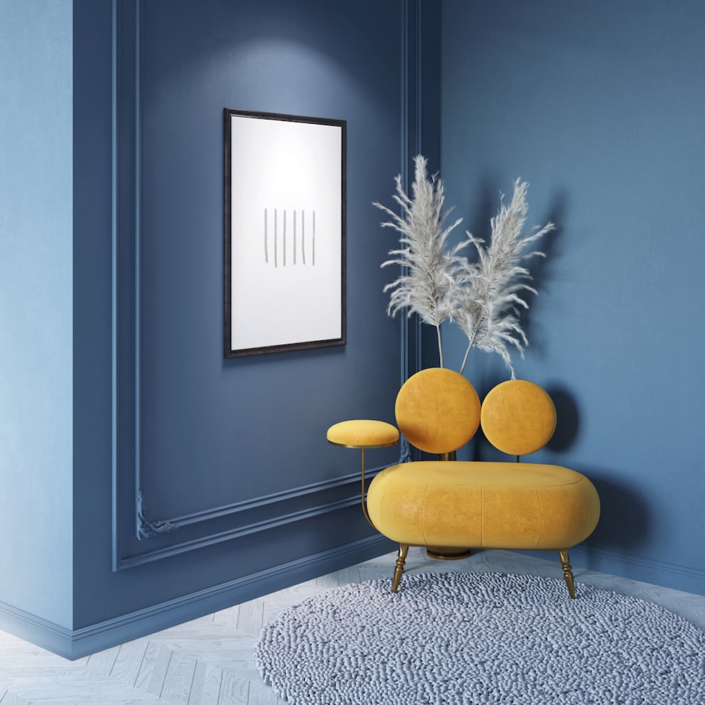 Yellow seating furniture in front of a blue wall
