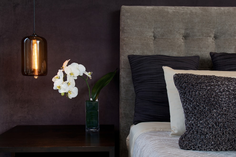 Stylish pendant lamp next to the bed as nightlight