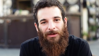 Dunkelhaariger Mann mit rotem Vollbart