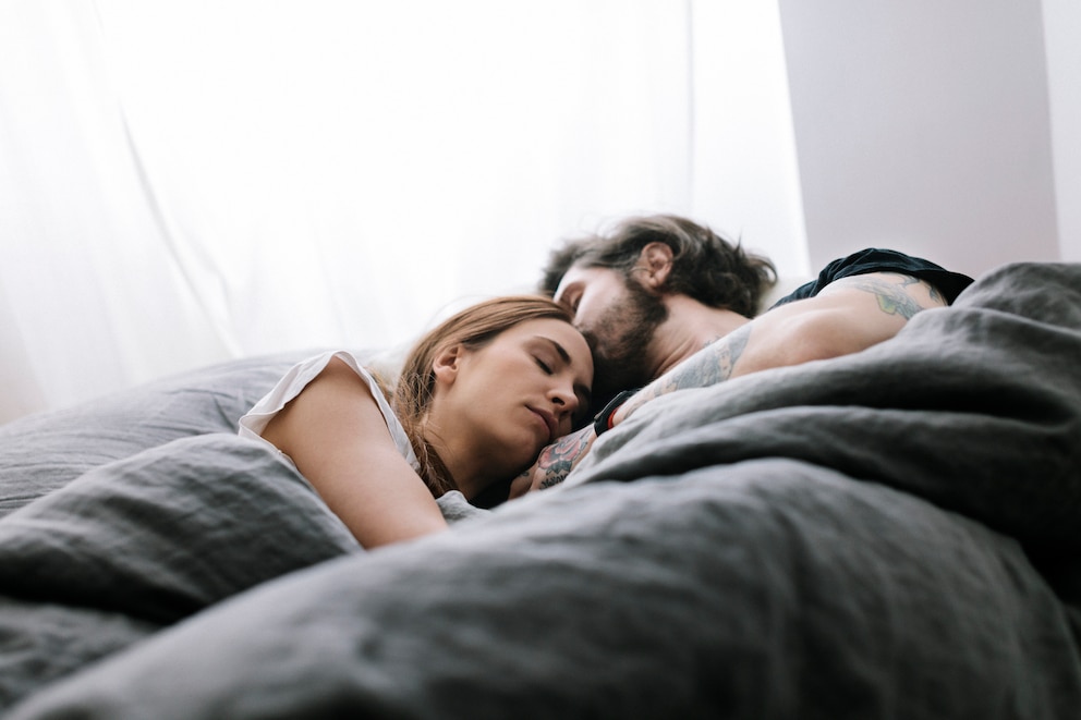 Mann und Frau kuscheln im Bett