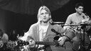 American singer and guitarist Kurt Cobain (1967 - 1994), performs with his group Nirvana at a taping of the television program 'MTV Unplugged,' New York, New York, Novemeber 18, 1993. Guitarist Pat Smear is visible at rear right. (Photo by Frank Micelotta/Getty Images)