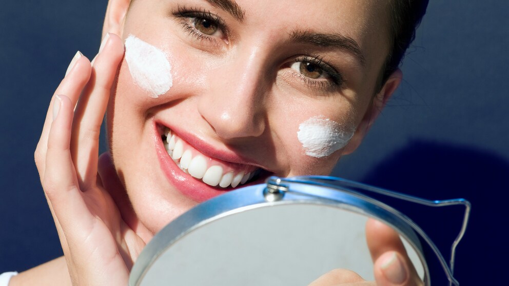 Frau mit Creme im Gesicht