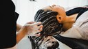 Frau lässt sich die Haare waschen