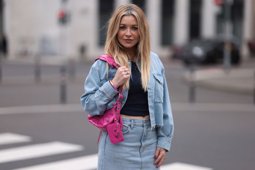 Eine pinke Tasche macht den sonst eher schlichten Look direkt zum Hingucker