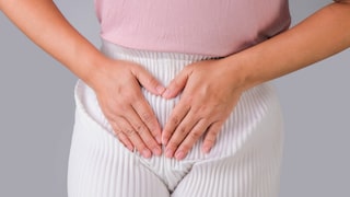 Woman with hands on her crotch isolated on white background. Female hand holding her crotch with pelvic pain or vaginal itching. gynecological problems. Health hygiene concept