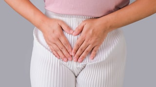 Woman with hands on her crotch isolated on white background. Female hand holding her crotch with pelvic pain or vaginal itching. gynecological problems. Health hygiene concept