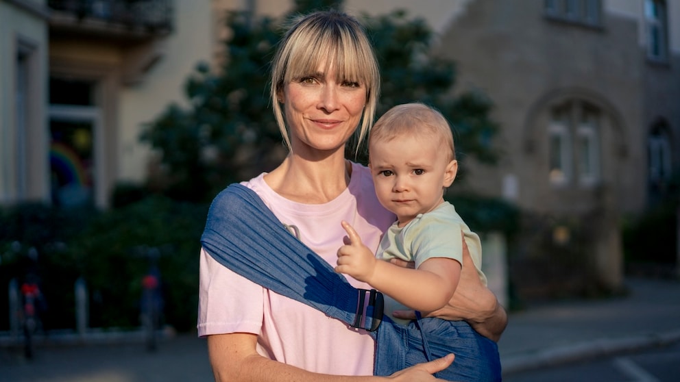 Frau um oder über 40 mit Baby. Beide sehen sehr süß aus irgendwie. Es geht um späten Kinderwunsch und ich entschuldige mich von Herzen, wenn ich die Dame hier älter mache, als sie ist.