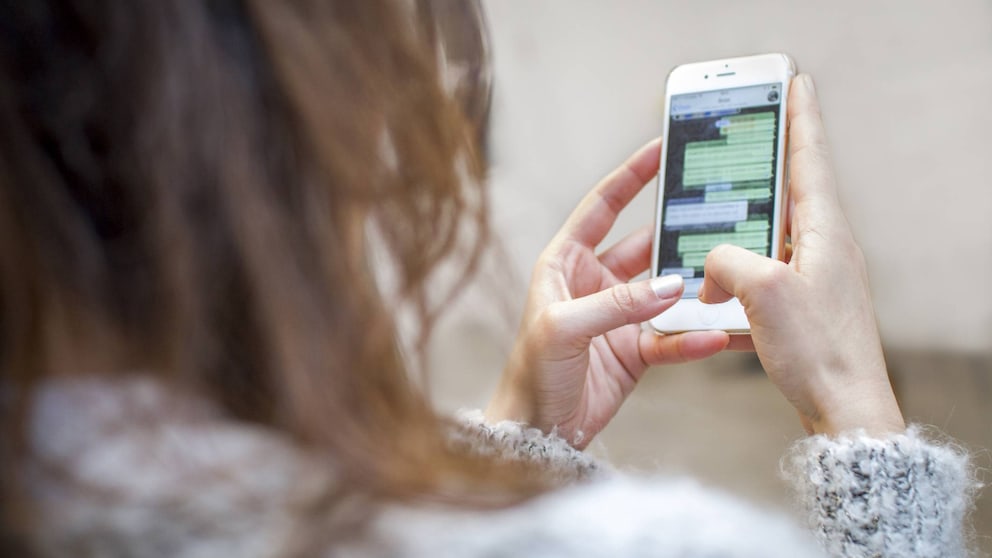 Frau chattet auf Smartphone