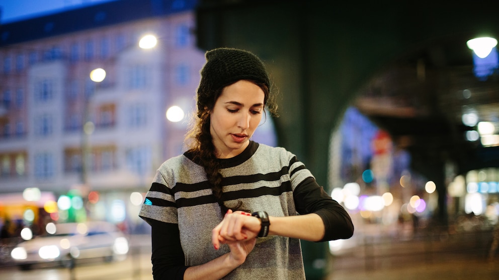 Woman checking her smart watch in city