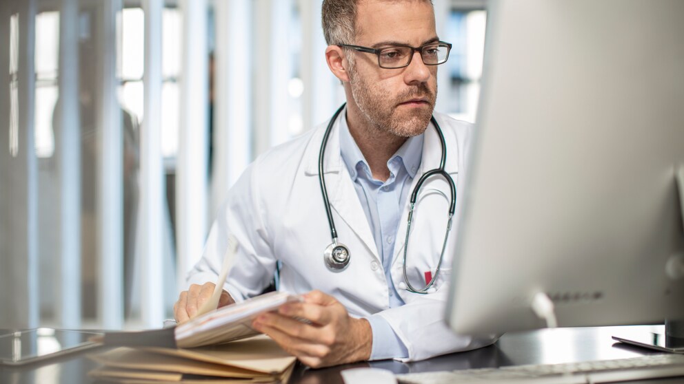 Cape Town, South Africa, Doctor sitting at desk