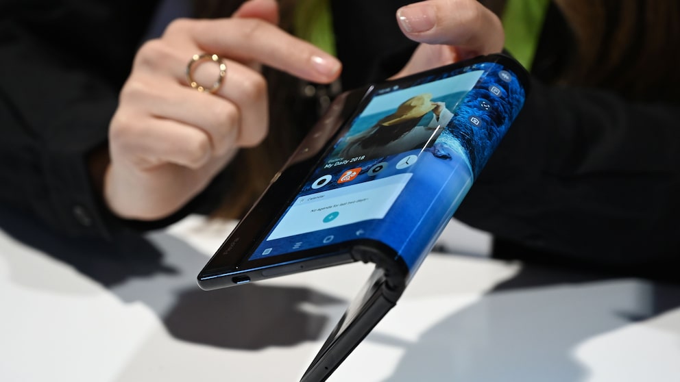 The folding and capabilities of the Royole FlexPai tablet and phone are demonstrated at the Royole booth at CES 2019 consumer electronics show, January 8, 2019 at the Las Vegas Convention Center in Las Vegas, Nevada.