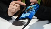 The folding and capabilities of the Royole FlexPai tablet and phone are demonstrated at the Royole booth at CES 2019 consumer electronics show, January 8, 2019 at the Las Vegas Convention Center in Las Vegas, Nevada.