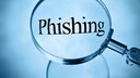 Lupe über einem „Phishing“-Schriftzug