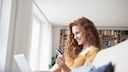 Woman at home shopping online