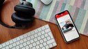 Smartphone mit geöffneter BUZZ-App liegt neben Tastatur