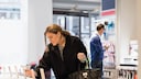 Frau betrachtet Smartphones im Handyshop